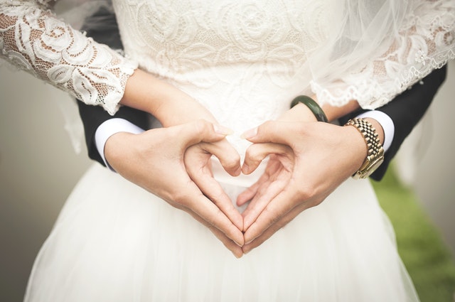 midsection of woman making heart shape with hands 256737